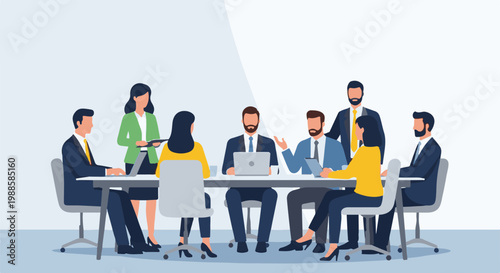 Diverse professionals in a meeting discussing strategy at a table with a laptop and tablet