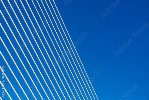Diagonal bridge cables against blue sky in Valencia