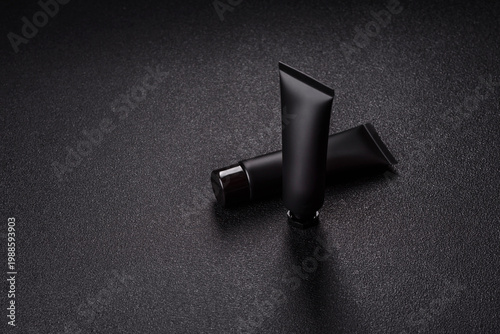 Obraz na płótnie Black empty plastic tube for cream, paste, or shampoo as a mockup