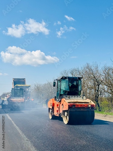 Roadwork road roller at hot asphalt
