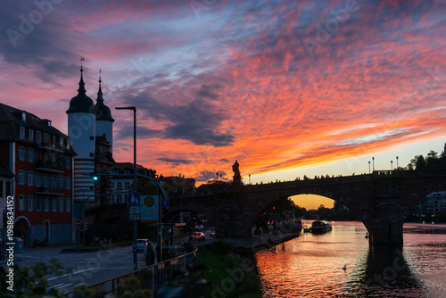 Karl Theodor Bridge Orange Sunset Neckar River Heidelberg. The Karl Theodor Bridge reflected in the Neckar River. Heidelberg, Germany.
