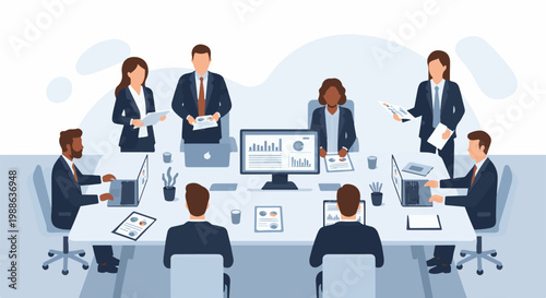 Team meeting with charts, computers, and paperwork at a boardroom table