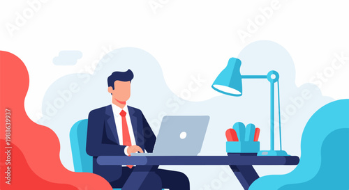 A man in a suit works on a laptop at a desk with a lamp