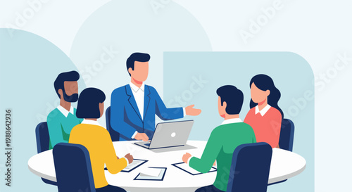 Diverse group collaborates around a table, discussing ideas with a laptop