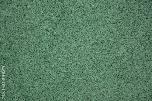 Green EPDM rubber crumb flooring texture. Seamless protective surface background pattern for outdoor kids playground or sports court.