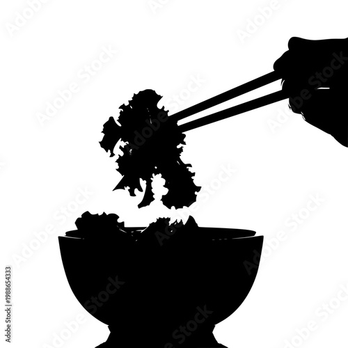 A pair of chopsticks lifting a piece of broccoli from a bowl of food