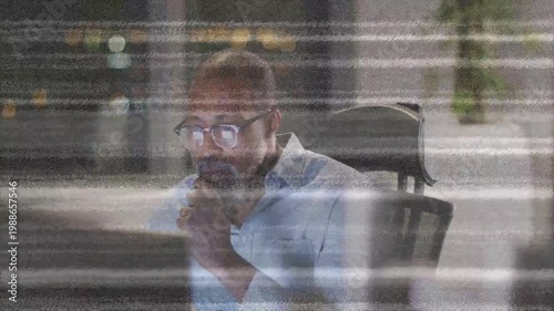 Monitor glow drawing man closer, he reaching keys, reviewing tech data while scanlines over glass