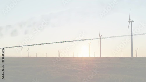 Wind farm turbines spinning at horizon as breeze pushing plume and sun moving, generating power