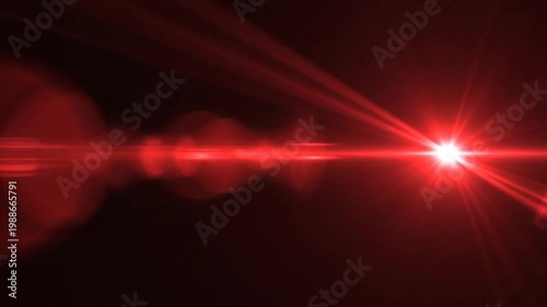 Bright red lens flare with starburst on black background