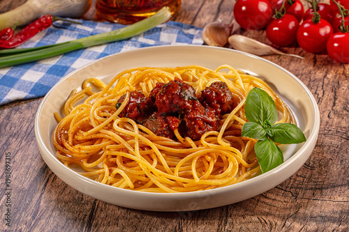 Obraz na płótnie Delicious spaghetti meatballs fresh basil wooden table background, Italian cuisi
