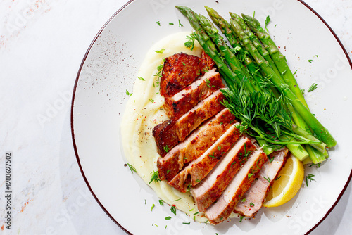 Εκτύπωση καμβά Sliced pork chop, with mashed potatoes and asparagus, on a white plate, homemade
