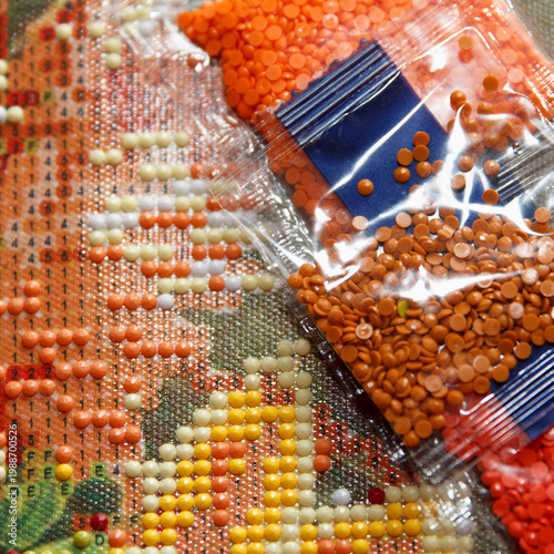 Colorful diamond painting supplies arranged on a floral background