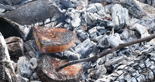 pieces of bread are fried on coals
