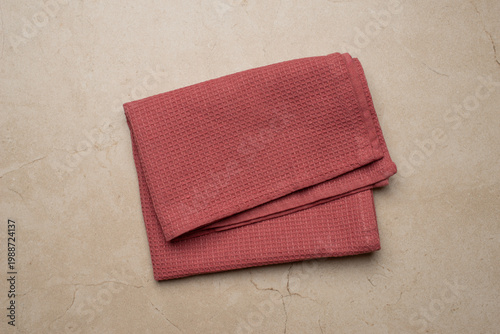Foto Folded Red Kitchen Towels on Beige Background, Minimal Rustic Flat Lay