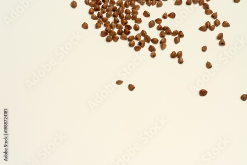 Konstfotografi Scattered Buckwheat Groats on Light Background with Copy Space