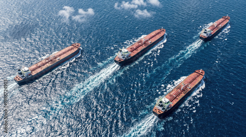 Fleet of Large Oil Tankers Sailing in Open Sea Aerial Shot