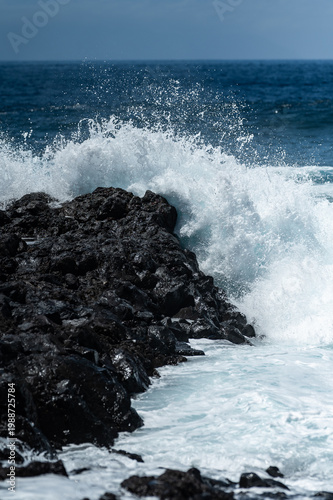 Turquoise ocean waves crashing on volcanic rocks coastline in Tenerife Canary Islands Spain, powerful Atlantic sea, blue water motion, dramatic seascape, summer travel destination, natural energy