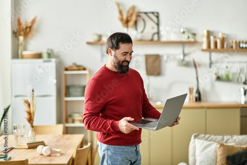Foto Handsome man in cozy home setting enjoying technology and laughter with laptop