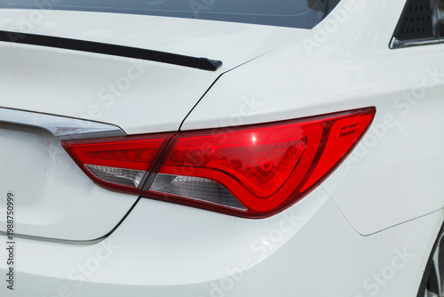 Close up of a modern car tail light on a metal car