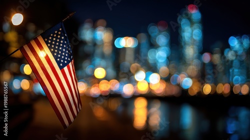 American flag in focus with city lights and blurred background