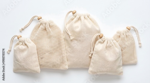 A collection of small, beige, mesh drawstring bags on a white background
