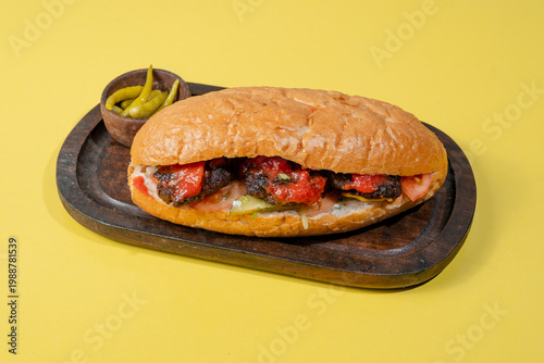 Kofta doner kebab on wooden tray isolated on yellow background
