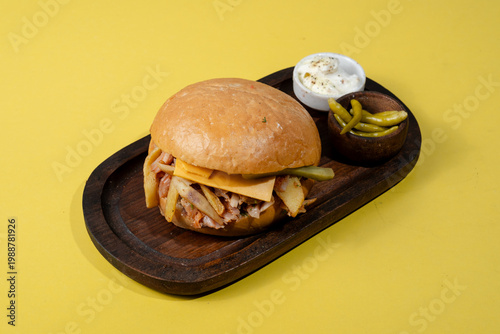 Tombik doner kebab with cheese on wooden tray isolated on yellow background