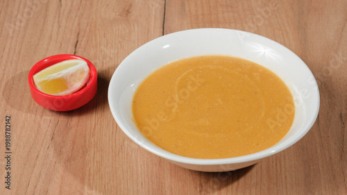 Lentil soup bowl with lemon slice
