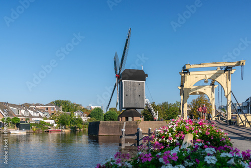 Leiden, Netherlands – September 21, 2024. Rembrandt Bridge and Molen De Put Windmill Leiden. The Rembrandt bridge over the Rijn canal with the de Put windmill in the background. Leiden, Netherlands.
