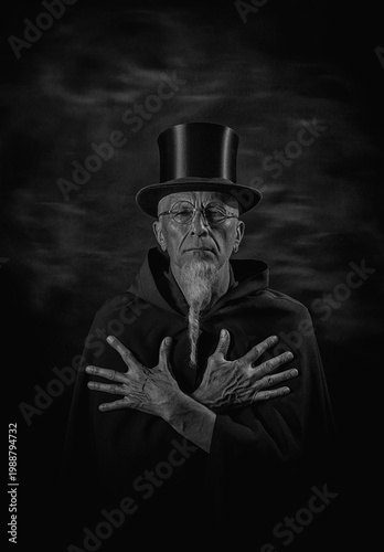 Φωτογραφία Monochrome Portrait of Man with Crossed Hands in Dark Cloak