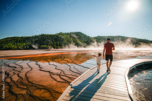 Fotografie Father and daughter walking boardwalk at Midway Geyser Basin in Yellowstone Nati