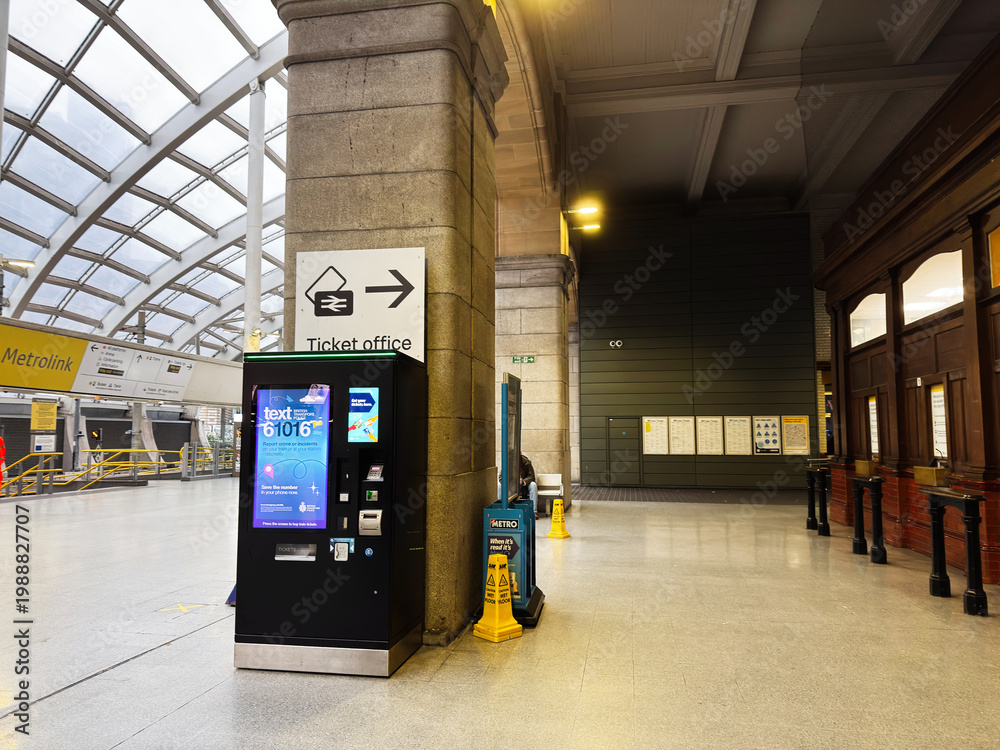 Fototapeta premium Ticket machine and ticket office in Manchester UK train station concourse with glass roof and modern interior