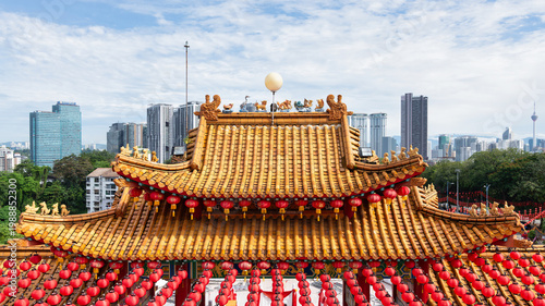Photography Thean Hou Temple roof with red lanterns and Kuala Lumpur city skyline including