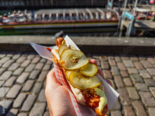 Traditional Danish Hot Dog Enjoyed by a Copenhagen Canal