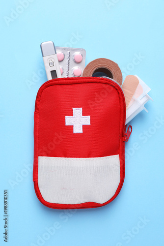 Obraz na płótnie First aid kit on light blue background, top view