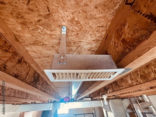 Konstfotografi Ceiling air vent register connected to HVAC ductwork in unfinished basement with