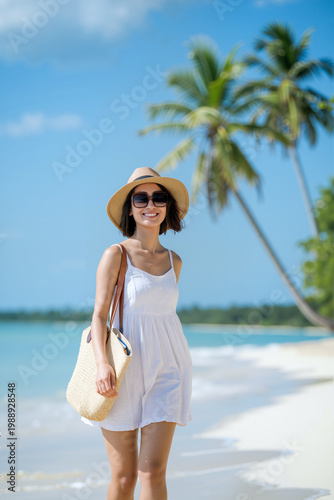 A smiling woman wearing a white dress, sunglasses, and a hat stands on a sandy beach under a clear sky, surrounded by palm trees and ocean waves. Summer holidays concept. Generative AI.