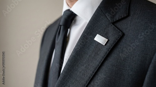Man in tailored suit with lapel pin displaying modern style  