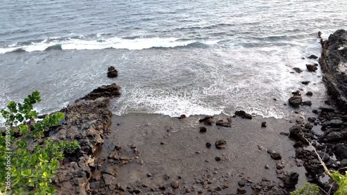A view from above the large coastal waves around the sandy rocks