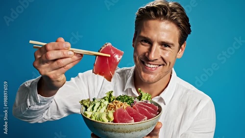 A happy man enjoying a healthy salad with chopsticks in a video about food and wellness