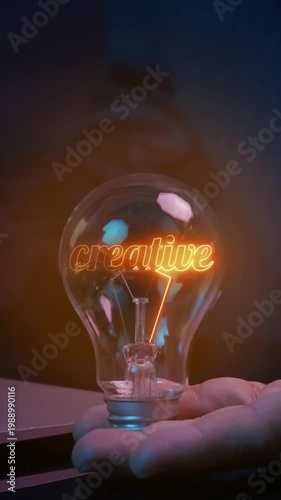 Creative thinking mindset concept. Idea, motivation, innovation, growth, imagination and inspiration. Personal development. Businessman showing glowing light bulb with text of CREATIVE inside.