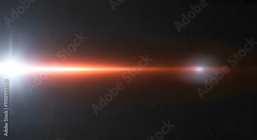 A bright light shines in the dark space with a beam of orange light