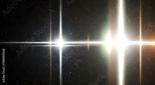 A bright light shines in the dark space with stars and lens flares