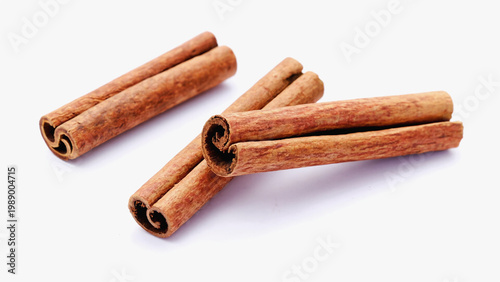 raw dry cinnamon sticks on isolated white background.ai 