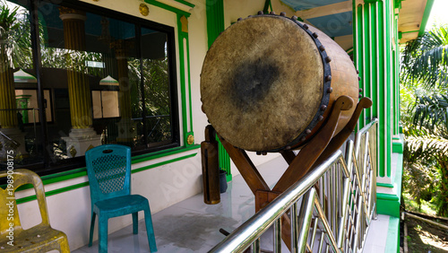 A bedug (beduk) is a musical instrument used for religious communication. In Indonesia, the bedug is typically used to signal the arrival of prayer times. It is typically made from cow or buffalo hide