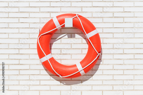 Lifebuoy on a white brick background