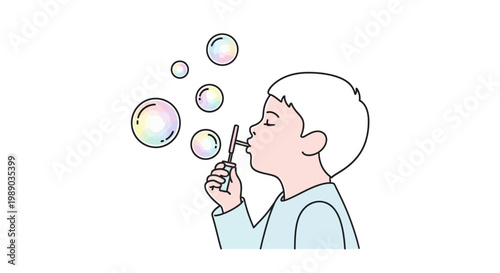 Little boy blowing soap bubbles outside.