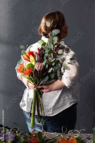 Woman Florist Holding Colorful Bouquet Behind Back