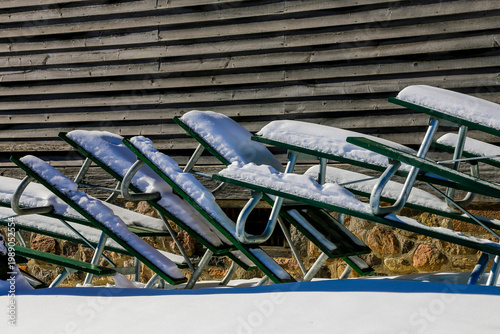 picnic tables in winter covered with snow