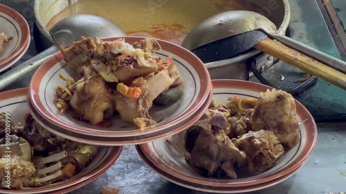 Tengkleng cooking, Sate Buntel Close-up of cooking process using traditional stove. Spicy Tengkleng or Tongseng - Indonesian food, Sate Buntel Solo
